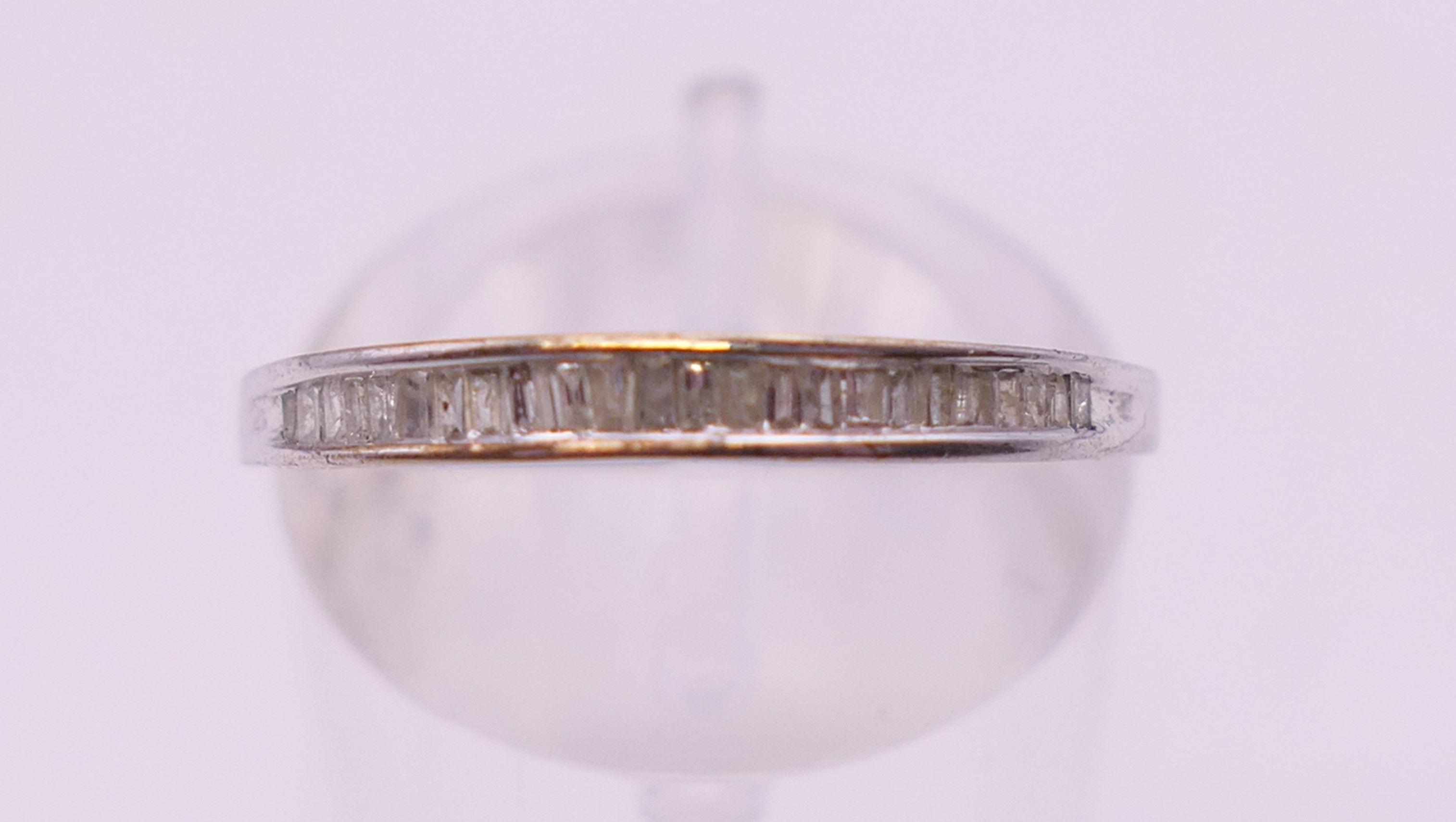 A 10 k white gold baguette diamond half eternity ring. Ring size N. - Image 2 of 5