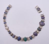 A silver and opal necklace. 39 cm long.