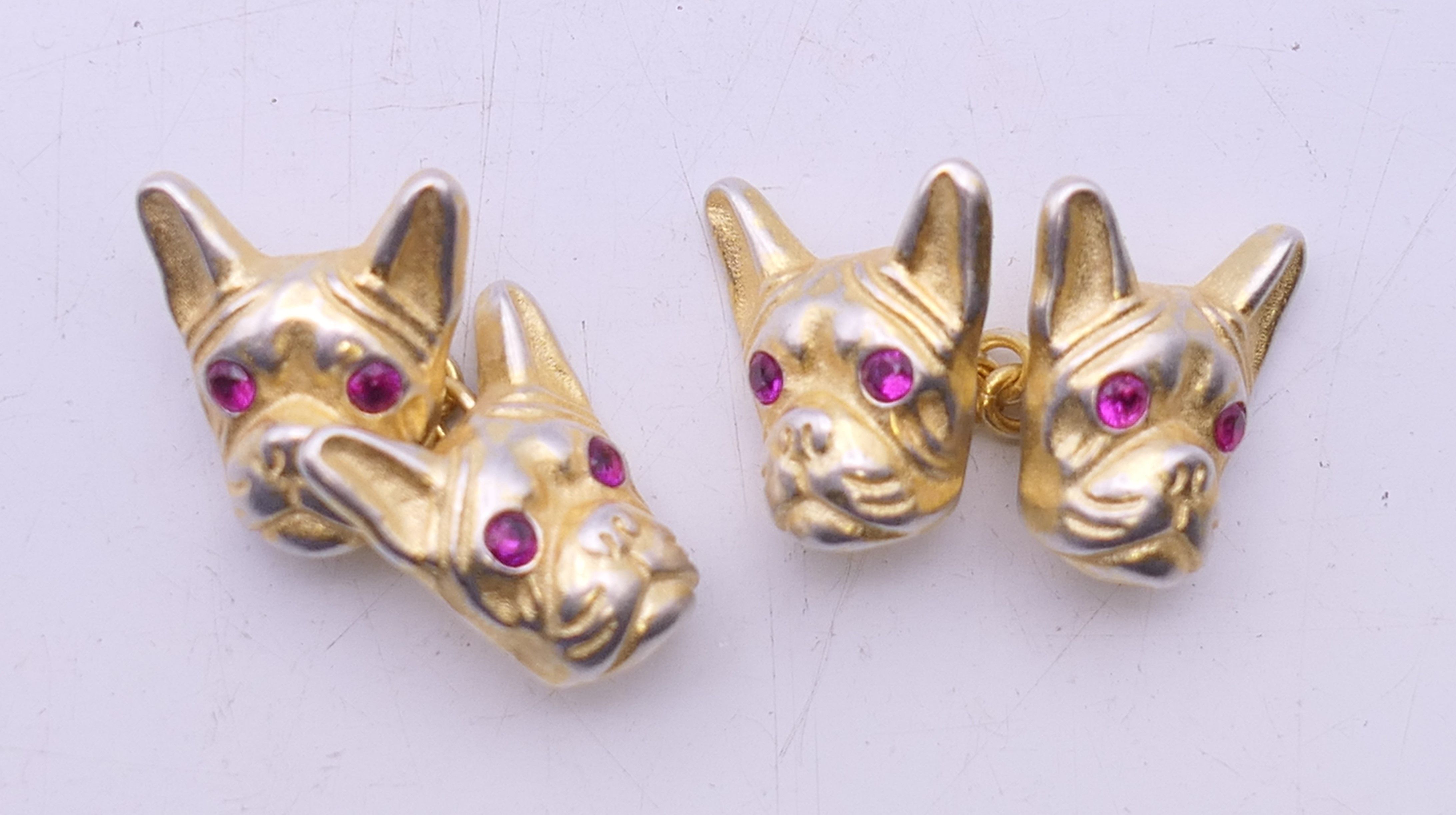 A pair of silver gilt cufflinks formed as French bulldog heads bearing Russian marks. 1.5 cm high.