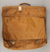 A tan leather suit bag. 60 cm wide.