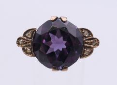 An unmarked gold amethyst and diamond ring. Ring size K/L.