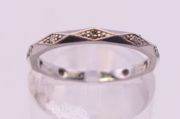 A platinum and diamond eternity ring. Ring size L/M. 2.5 grammes total weight.