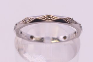 A platinum and diamond eternity ring. Ring size L/M. 2.5 grammes total weight.