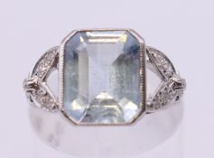 A platinum aquamarine and diamond ring. Ring size is L/M.