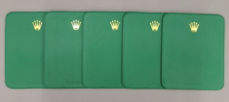 Five Rolex placemats. 19.5 x 23.5 cm.