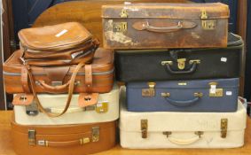 A quantity of vintage suitcases, shoe lasts, a pair of ice skates and a pair of leather boots.