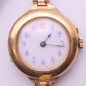 A 9 ct gold cased ladies wristwatch on metal strap. 2.5 cm wide.
