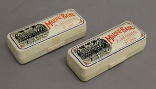 Two Hohner Marine Band harmonicas, boxed. 11 cm long.