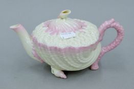 A Belleek porcelain teapot. 20.5 cm long.