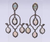 A pair of diamond and opal drop earrings. 5 cm high.
