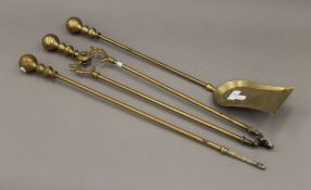 A set of three brass fire irons. The shovel 67 cm long.