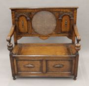 An early 20th century carved oak settle. 106 cm wide.