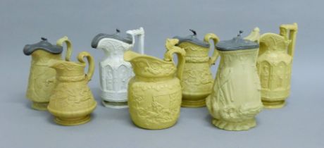 A collection of Victorian relief jugs. The largest 23 cm high.
