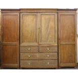 A 19th century mahogany compactum wardrobe. 193 cm high x 250 cm wide.