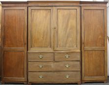 A 19th century mahogany compactum wardrobe. 193 cm high x 250 cm wide.