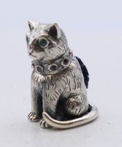 A silver cat pin cushion. 2.5 cm high.