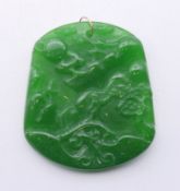 A Chinese apple green jade pendant with gold suspension loop. 5.5 cm high.