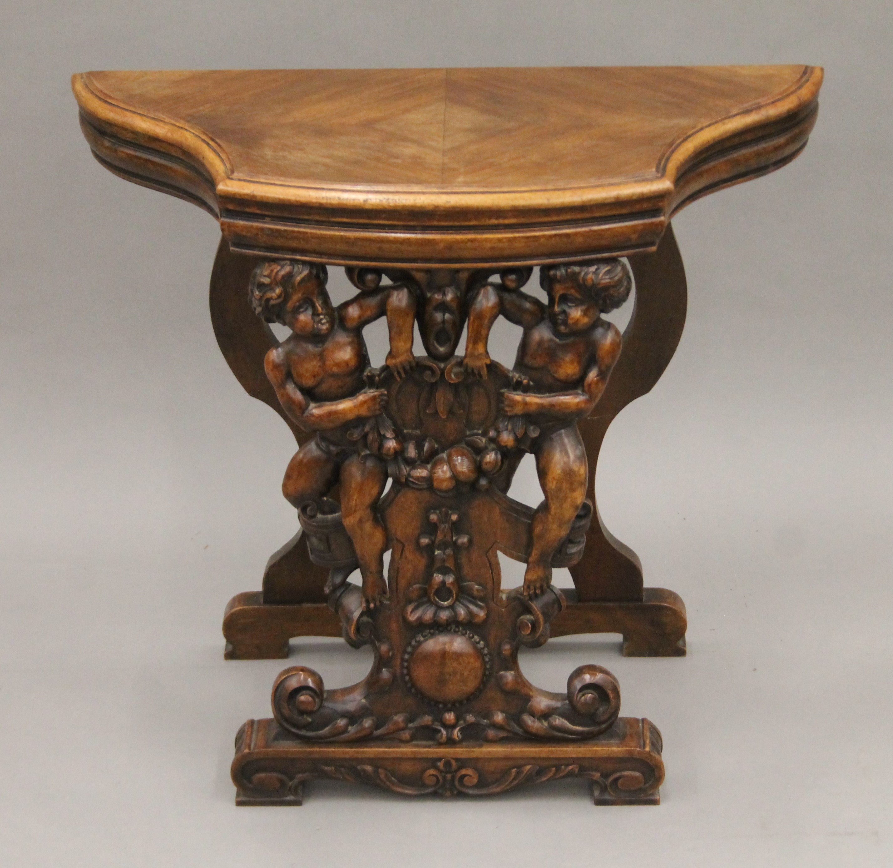 A 19th century carved walnut stool. 65.5 cm wide.