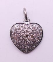 A diamond-set heart-form charm. 1.5 cm high.