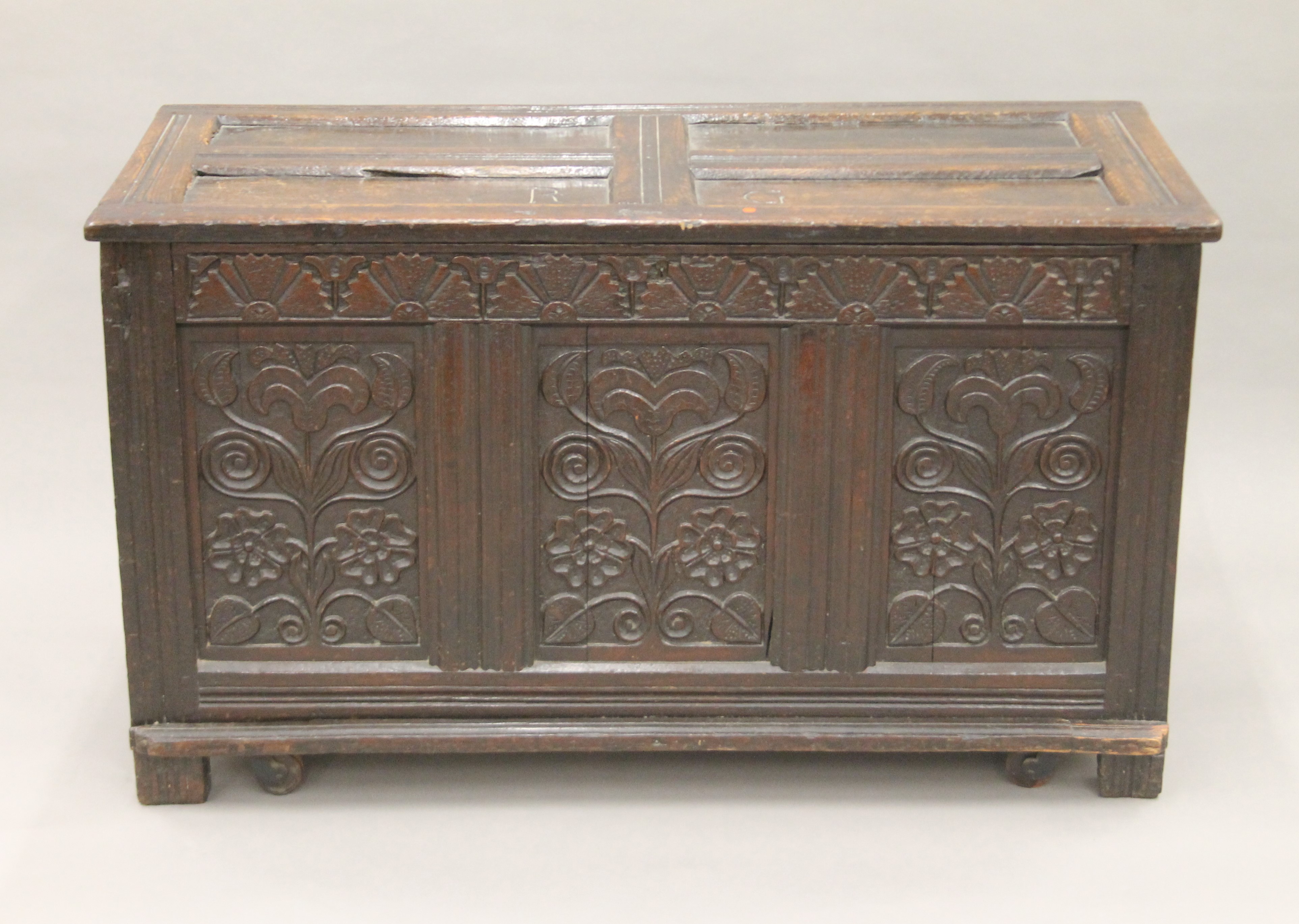 An 18th century carved oak coffer. 123 cm long.