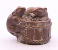 A model of two rats on a barrel. 4 cm long.