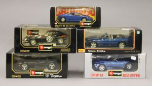 Five boxed Burago die cast cars. The largest box 31.5 cm long.