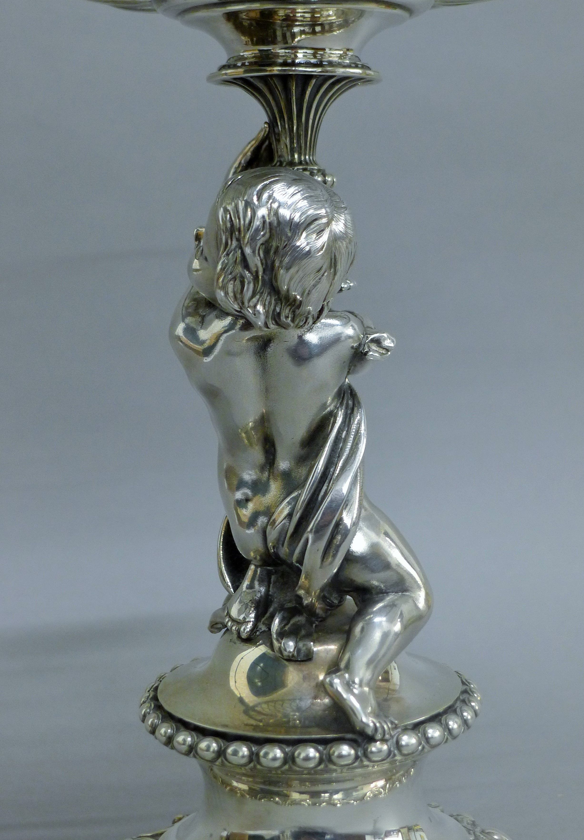 A Victorian silver centrepiece, the stem formed as a putto holding a pierced basket, - Image 4 of 10