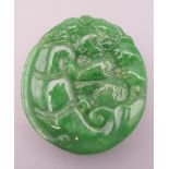 A Chinese carved hardstone pendant, possibly jadite. 4.5 cm high.