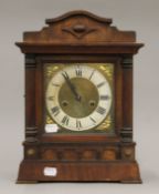 A late 19th German walnut-cased mantle clock. 36 cm high.