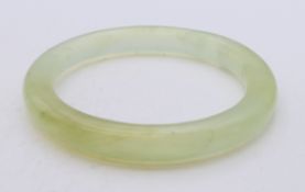 An icy jade bangle. Inner diameter approximately 6 cm.
