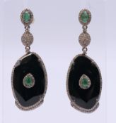 A pair of Art Deco-style diamond-set earrings. 5 cm high.