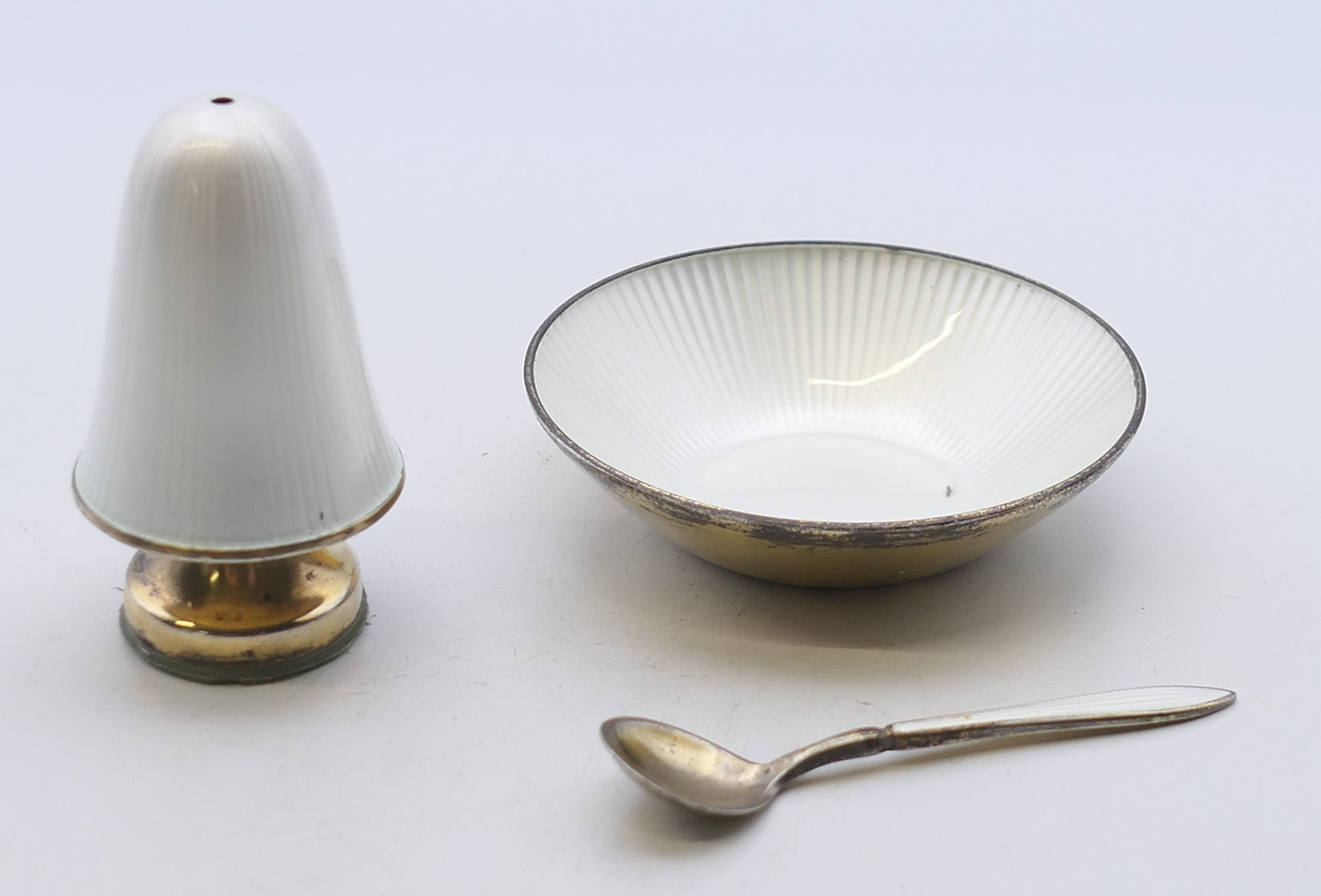 David Anderson (Norwegian), a white enamel and silver salt, spoon and pepper. The latter 5 cm high.