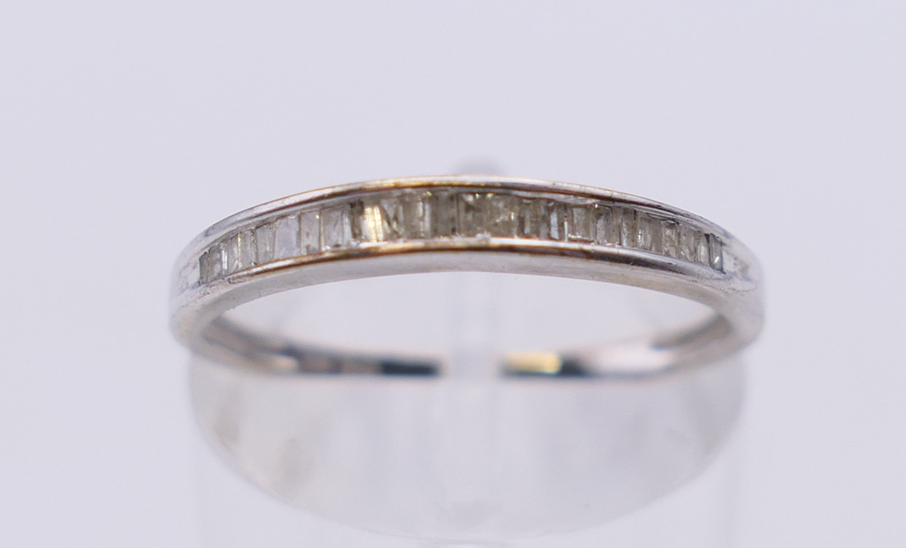 A 10 k white gold baguette diamond half eternity ring. Ring size N.