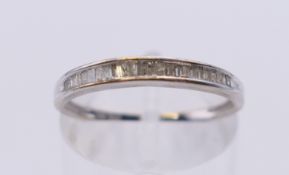 A 10 k white gold baguette diamond half eternity ring. Ring size N.