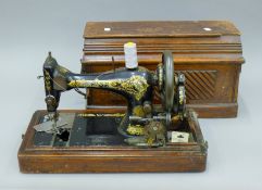 A vintage cased Singer sewing machine. 47 cm long.