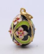 A silver and enamel egg pendant bearing Russian marks. 2.5 cm high.