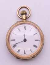 An 18 ct gold cased fob watch. 3.25 cm diameter. 31.7 grammes total weight.