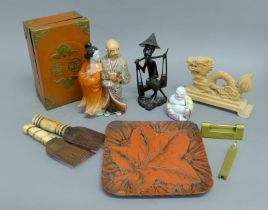 A quantity of Oriental and Ethnic items including porcelain figures, a tray etc.