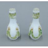 A pair of 19th century Continental porcelain scent bottles. Each 11 cm high.