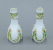 A pair of 19th century Continental porcelain scent bottles. Each 11 cm high.