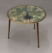 A small round table, the top decorated with peacock feather design. 60 cm diameter.