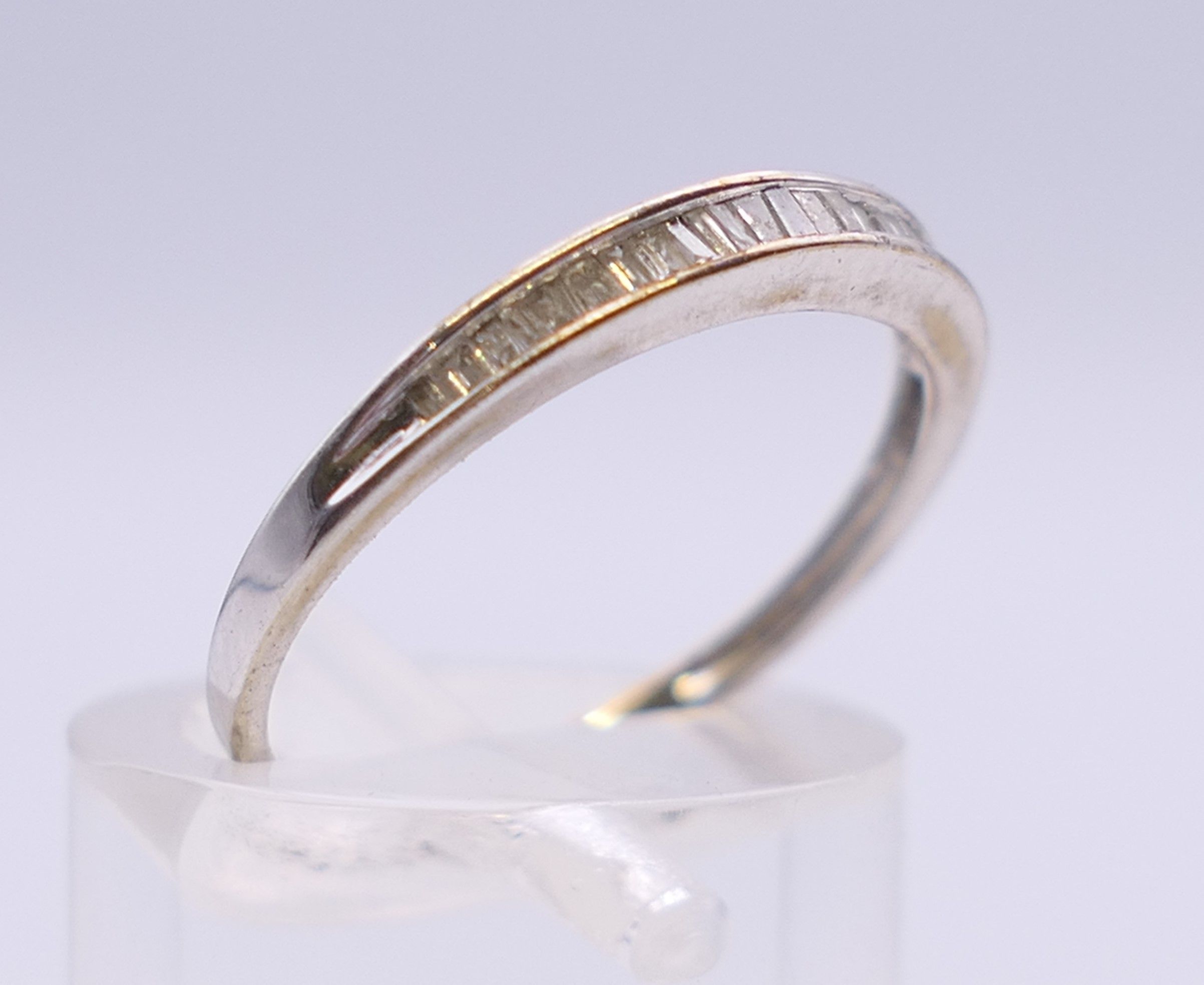A 10 k white gold baguette diamond half eternity ring. Ring size N. - Image 3 of 5
