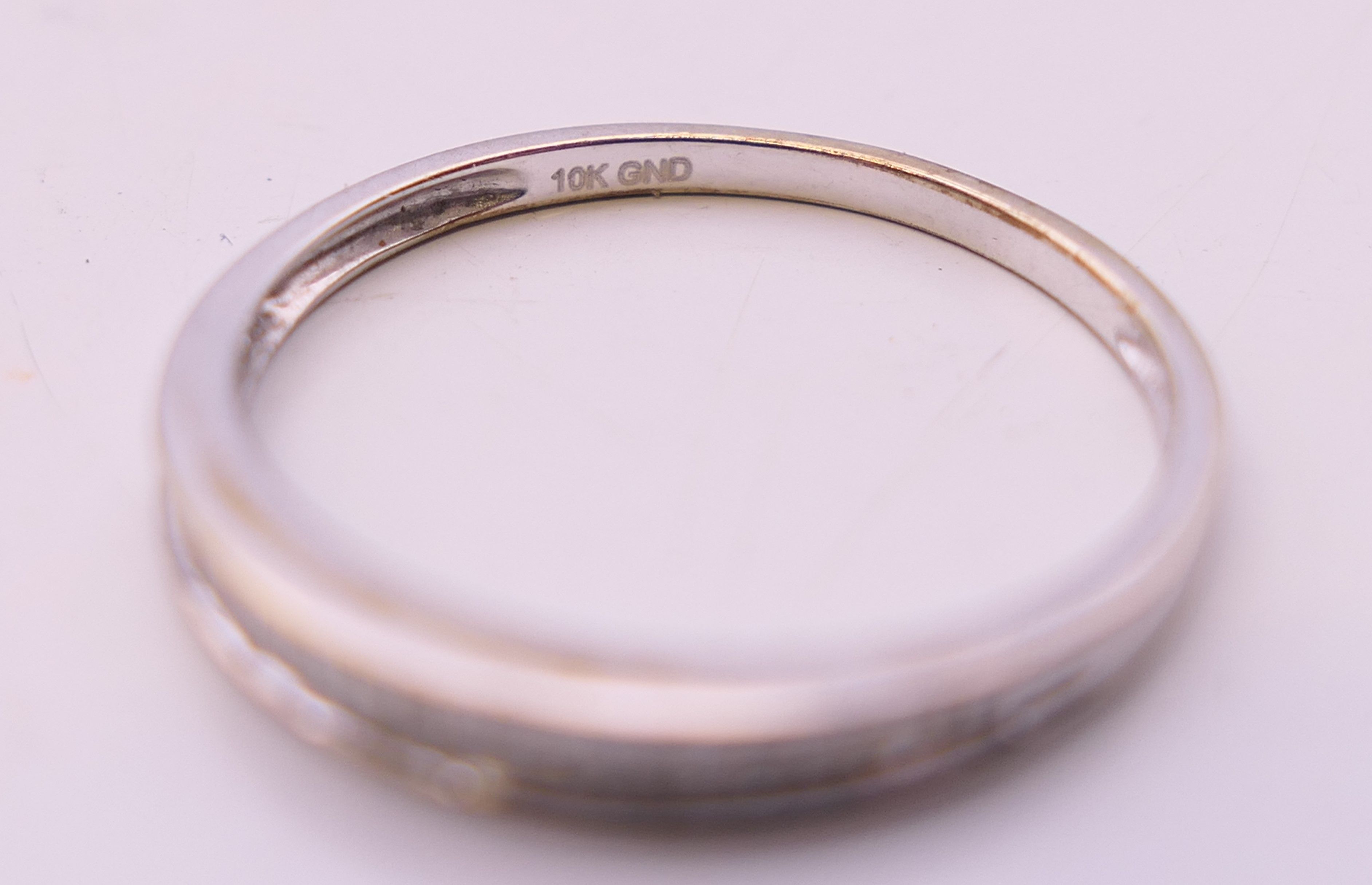A 10 k white gold baguette diamond half eternity ring. Ring size N. - Image 4 of 5