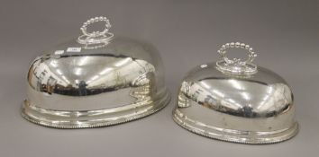 Two silver-plated meat covers. The largest 46 cm long.