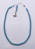 A turquoise bead necklace. 60 cm long.