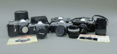 A quantity of cameras including working SLR's, Canon, Pentax, Minolta (5) and three extra lenses.