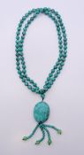 A string of turquoise beads. 86 cm long.