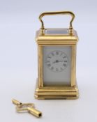 A gilt bronze miniature carriage clock. 9.5 cm high.