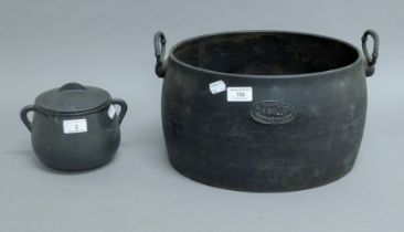 Two cast iron cooking pots. The largest 37 cm wide.