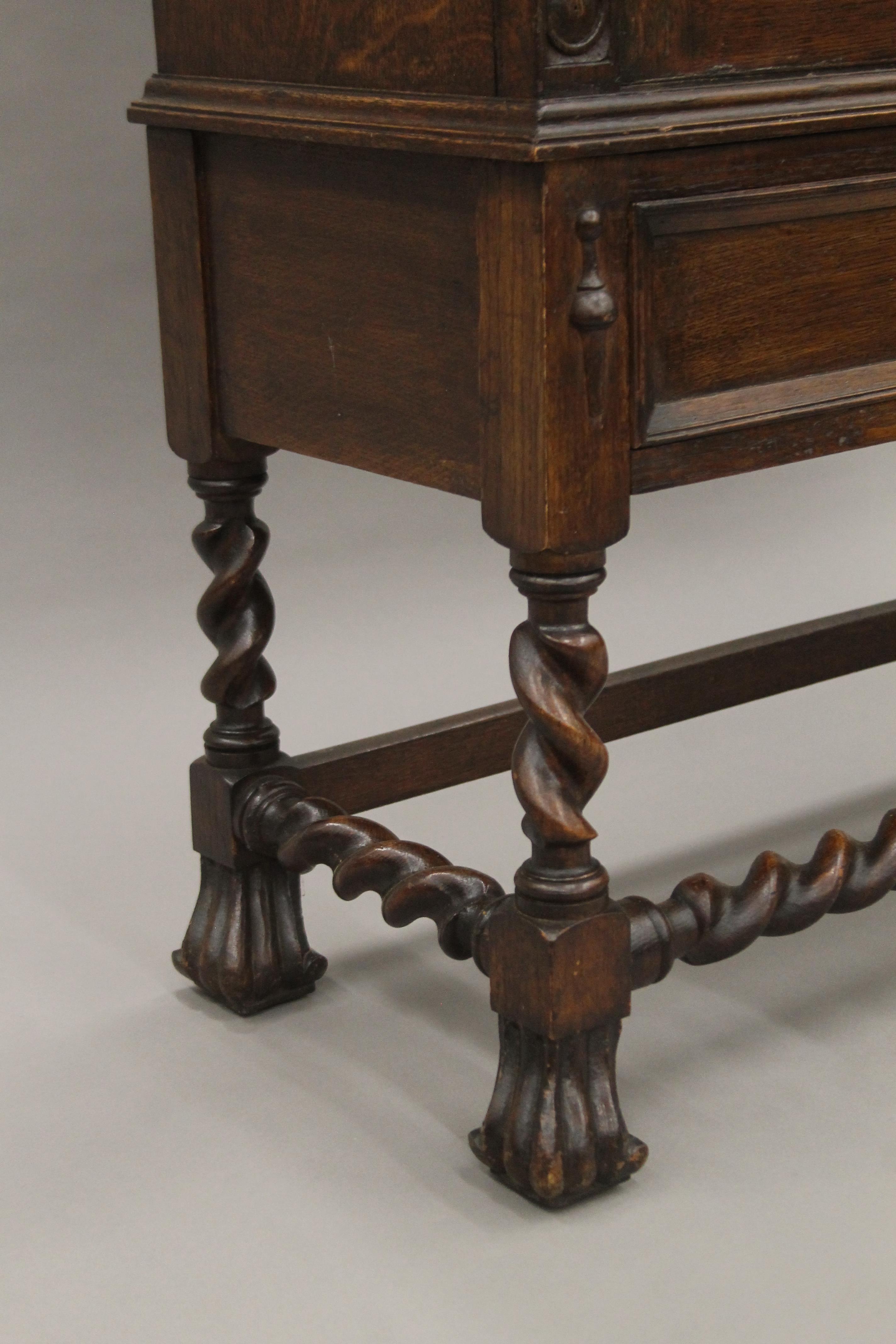 An early 20th century carved oak two door glazed barley twist cabinet. - Image 5 of 5
